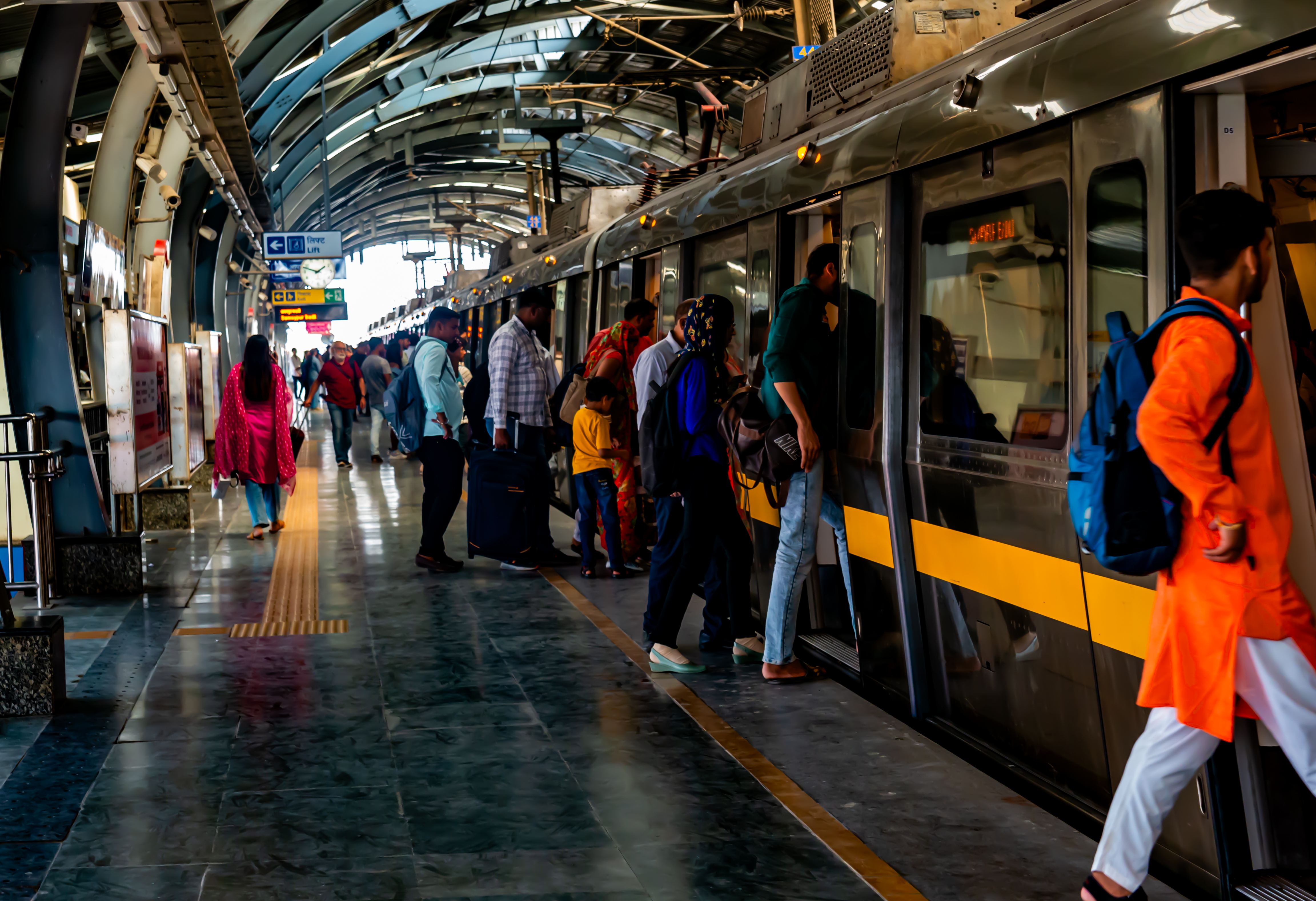 People boarding a Delhi Metro train